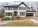 Charming two-story home with black and white accents, a well-manicured lawn and an attached two car garage at 2321 Birdie Ln, Duluth, GA 30096