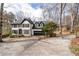 Exterior view of home from driveway showcasing the well manicured lawn and mature trees at 2321 Birdie Ln, Duluth, GA 30096