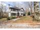 View of home from driveway showing mature trees and landscaping at 2321 Birdie Ln, Duluth, GA 30096