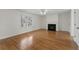 Inviting living room features gleaming hardwood floors, a fireplace, and a large window at 2321 Birdie Ln, Duluth, GA 30096