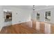 Open-concept living room featuring hardwood floors, neutral paint, and lots of light at 2321 Birdie Ln, Duluth, GA 30096