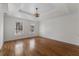 Spacious main bedroom with tray ceiling, modern lighting, and hardwood floors at 2321 Birdie Ln, Duluth, GA 30096