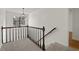 Staircase with wooden railing, plush carpet, and decorative chandelier at 2321 Birdie Ln, Duluth, GA 30096