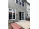 Backyard view featuring sliding door, small patio, and outdoor hose at 2394 Elkhorn Ter, Duluth, GA 30096