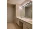 Bright bathroom showcasing double sinks, vanity, and neutral tile flooring at 2394 Elkhorn Ter, Duluth, GA 30096