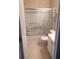 Bathroom featuring a shower-tub combination with sliding glass doors and a convenient towel rack at 2394 Elkhorn Ter, Duluth, GA 30096