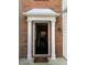 Inviting front door features classic white trim and brick exterior accents at 2394 Elkhorn Ter, Duluth, GA 30096