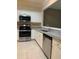Well-lit kitchen with stainless steel appliances, granite counters, and white cabinets at 2394 Elkhorn Ter, Duluth, GA 30096