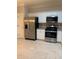 A bright kitchen offers stainless steel appliances, tile flooring, and ample cabinet space at 2394 Elkhorn Ter, Duluth, GA 30096