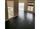 Open concept living space with hardwood floors, fireplace and view to the kitchen at 2394 Elkhorn Ter, Duluth, GA 30096