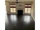 Bright living room featuring a fireplace, two windows, and hardwood floors at 2394 Elkhorn Ter, Duluth, GA 30096