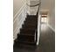 Beautiful staircase featuring dark wood steps, white trim, and dark handrail at 2394 Elkhorn Ter, Duluth, GA 30096