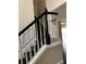 Close up on the staircase featuring dark wood steps and white trim with black handrail at 2394 Elkhorn Ter, Duluth, GA 30096