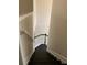 Elegant staircase featuring dark wood steps and white trim with dark handrail at 2394 Elkhorn Ter, Duluth, GA 30096