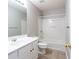 Clean bathroom with white vanity, tile flooring, and tub-shower combo at 11338 Musette Cir, Alpharetta, GA 30009