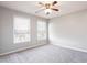 Bedroom with neutral walls, carpet, and two bright windows at 11338 Musette Cir, Alpharetta, GA 30009