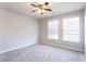 Bedroom with neutral walls, carpet, and two bright windows at 11338 Musette Cir, Alpharetta, GA 30009