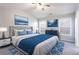 Main bedroom with bright windows, tufted headboard, and tasteful artwork at 11338 Musette Cir, Alpharetta, GA 30009
