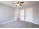 Bright bedroom with neutral walls, carpet, and ceiling fan at 11338 Musette Cir, Alpharetta, GA 30009