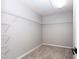Bright walk-in closet featuring wire shelving and neutral carpeting at 11338 Musette Cir, Alpharetta, GA 30009