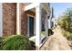 Townhome front door featuring a brick facade and white pillars at 11338 Musette Cir, Alpharetta, GA 30009