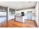 Open-concept kitchen featuring an island and white cabinets at 11338 Musette Cir, Alpharetta, GA 30009