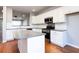 Modern kitchen features an island, stainless steel appliances, and ample counter space at 11338 Musette Cir, Alpharetta, GA 30009