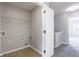 Neutral colored laundry room with shelving and tiled floor at 11338 Musette Cir, Alpharetta, GA 30009