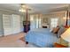 Spacious primary bedroom with four-poster bed, fireplace, and built-in cabinets, bathed in natural light at 3701 W Lawrenceville St, Duluth, GA 30096