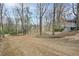 Long gravel driveway leading to a home surrounded by mature trees, providing privacy and natural beauty at 3701 W Lawrenceville St, Duluth, GA 30096