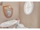 Comfortable bathroom with pedestal sink and oval window at 1527 Markan Ne Dr, Atlanta, GA 30306