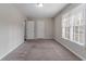 Neutral bedroom with carpet, two closets and a large window at 3174 Palm Tree Dr, Lithonia, GA 30038