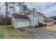 Exterior view of a two-story home with a two-car garage and driveway at 3174 Palm Tree Dr, Lithonia, GA 30038