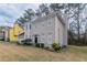 Side view of a two story house showing yard and bay window at 3174 Palm Tree Dr, Lithonia, GA 30038