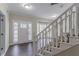 Bright foyer with wood floors, white trim, and a staircase at 3174 Palm Tree Dr, Lithonia, GA 30038