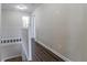 Upstairs hallway with wood floors leads to bedrooms and bathrooms at 3174 Palm Tree Dr, Lithonia, GA 30038