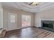 Bright living room featuring a fireplace, a large window, and hardwood floors at 3174 Palm Tree Dr, Lithonia, GA 30038