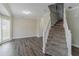 Open living area with wood floors and a view of the staircase at 3174 Palm Tree Dr, Lithonia, GA 30038