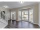 Living room features wood floors, white trim, and large bay window at 3174 Palm Tree Dr, Lithonia, GA 30038