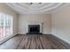 Spacious living room featuring a fireplace, a large window, and hardwood floors at 3174 Palm Tree Dr, Lithonia, GA 30038