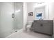 Modern bathroom featuring a glass enclosed shower, gray vanity, and white tiled floors for a clean, minimalist look at 608 Goldsmith Ct # 113, Johns Creek, GA 30022