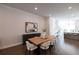 Stylish dining area with a wooden table, modern chairs, and hardwood flooring at 608 Goldsmith Ct # 113, Johns Creek, GA 30022