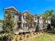 Beautiful brick townhomes featuring black metal fences and professionally landscaped front yards at 608 Goldsmith Ct # 113, Johns Creek, GA 30022