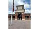 Front view of Johns Creek High School with brick facade and a flagpole under a bright blue sky at 608 Goldsmith Ct # 113, Johns Creek, GA 30022