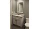 Bathroom with white vanity, mirror, and toilet and gray vinyl flooring at 7382 Knox Bridge Hwy, Canton, GA 30114