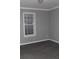 Bedroom with gray walls, light gray vinyl flooring, and a window with horizontal blinds at 7382 Knox Bridge Hwy, Canton, GA 30114