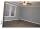 Bedroom features neutral walls, modern ceiling fan, and lots of natural light from windows at 7382 Knox Bridge Hwy, Canton, GA 30114