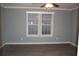 A grey bedroom with two windows covered in blinds at 7382 Knox Bridge Hwy, Canton, GA 30114