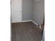 Empty closet with gray vinyl flooring, gray walls, and white door at 7382 Knox Bridge Hwy, Canton, GA 30114