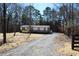 View of home with long driveway, neutral tones, charming porch, and mature trees at 7382 Knox Bridge Hwy, Canton, GA 30114